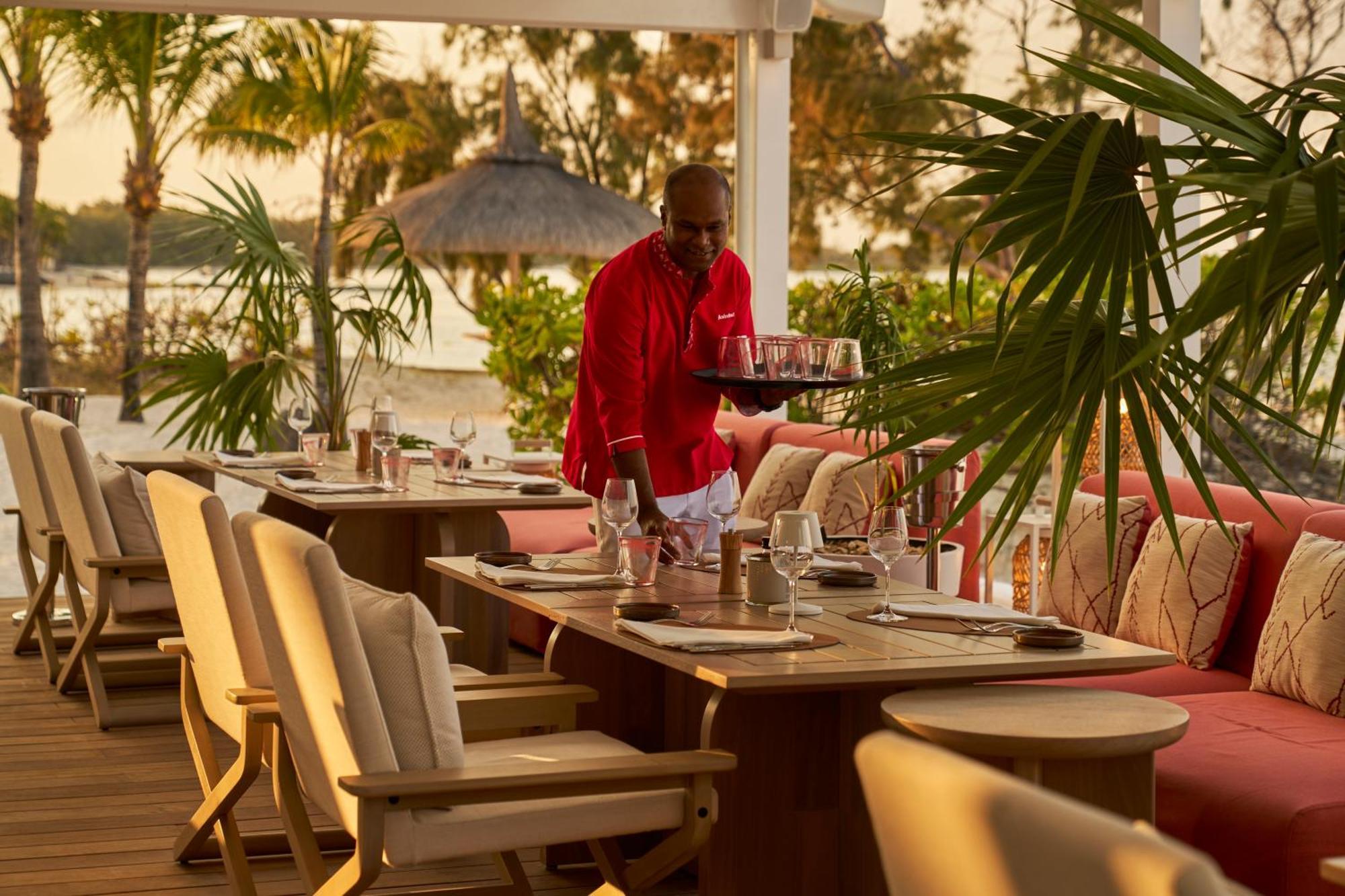 Lux* Belle Mare Resort & Villas Экстерьер фото A waiter at work