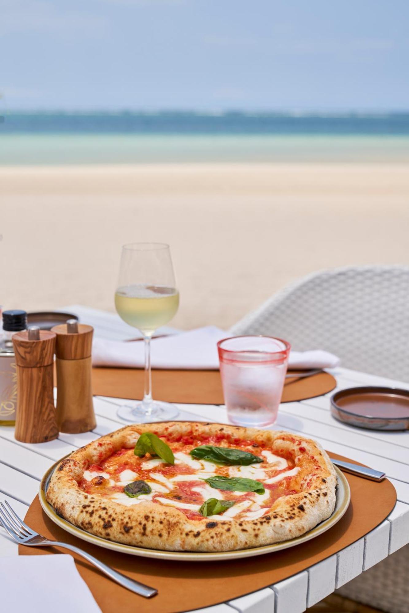Lux* Belle Mare Resort & Villas Экстерьер фото A glass of wine with a pizza