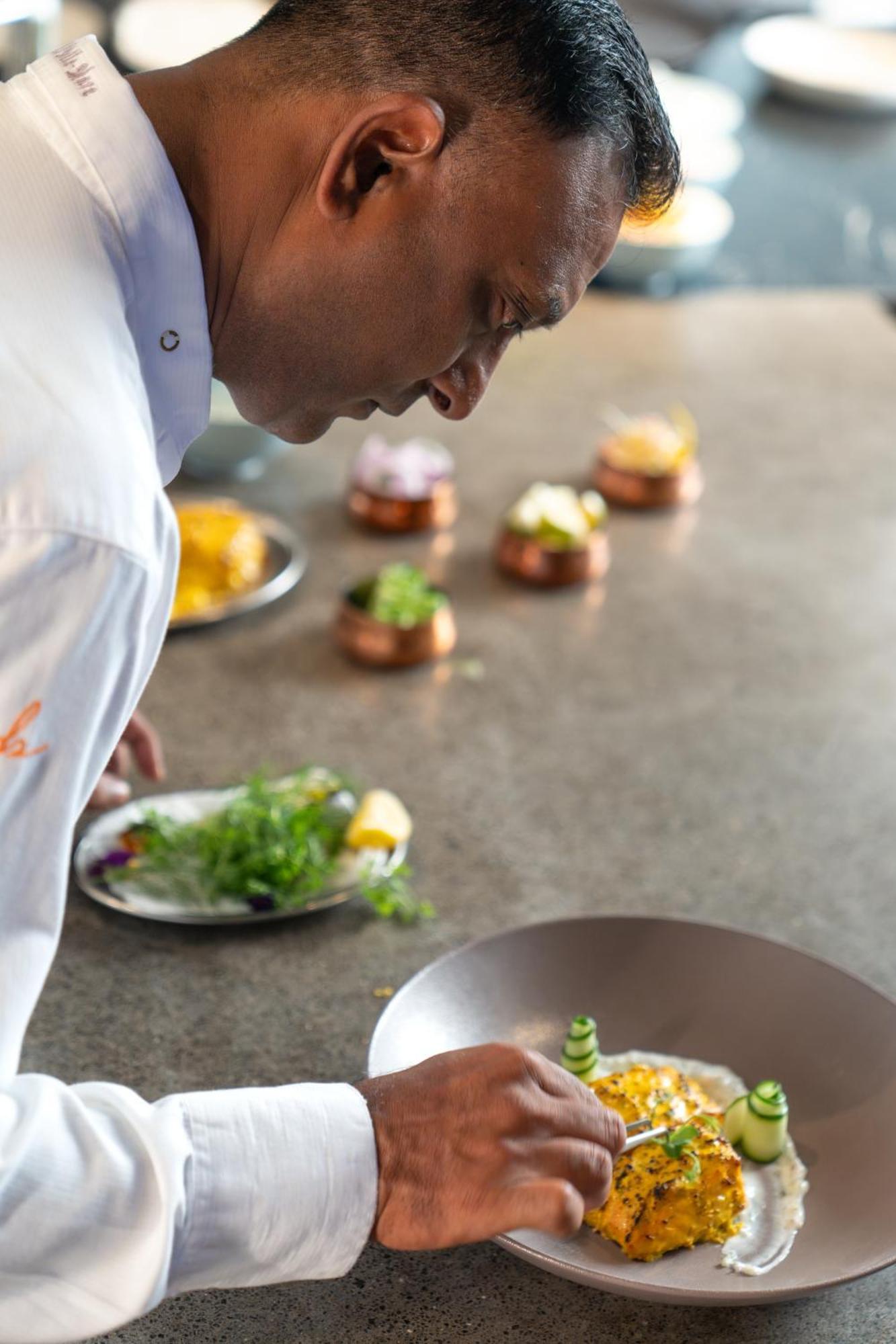 Lux* Belle Mare Resort & Villas Экстерьер фото A chef smelling food