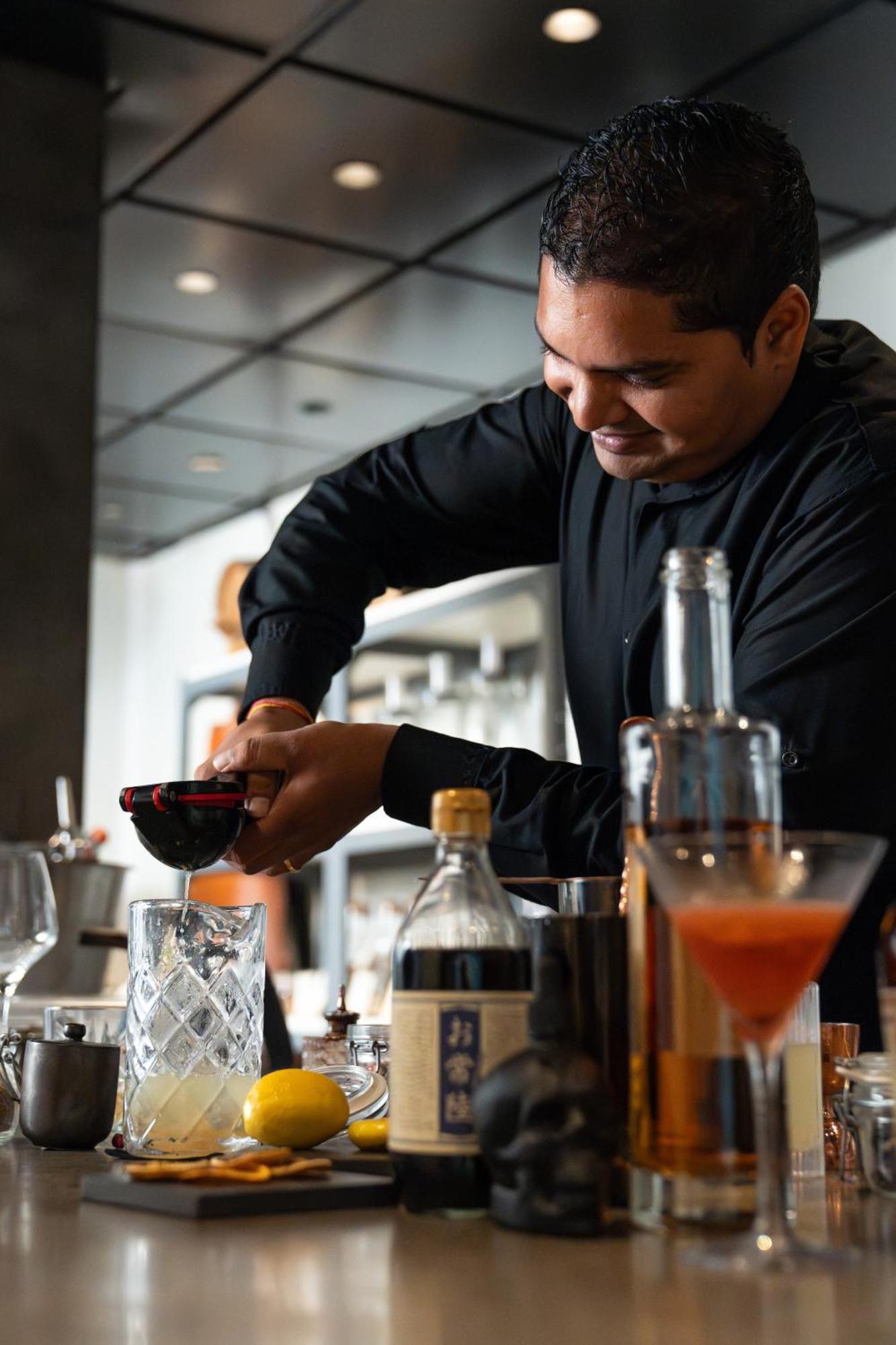 Lux* Belle Mare Resort & Villas Экстерьер фото A bartender at work